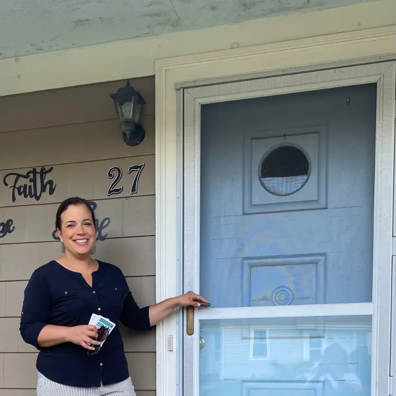 Suzy canvassing at a resident's front door