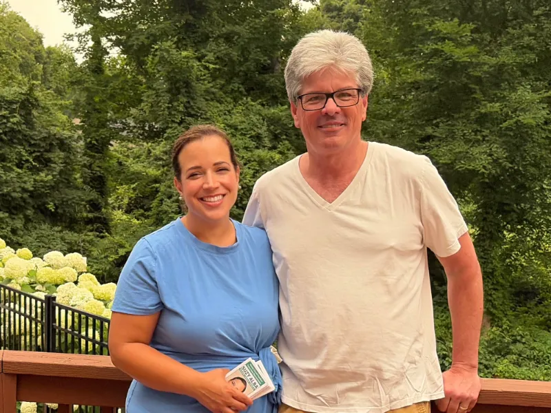 Suzy with a supporter on a backyard deck