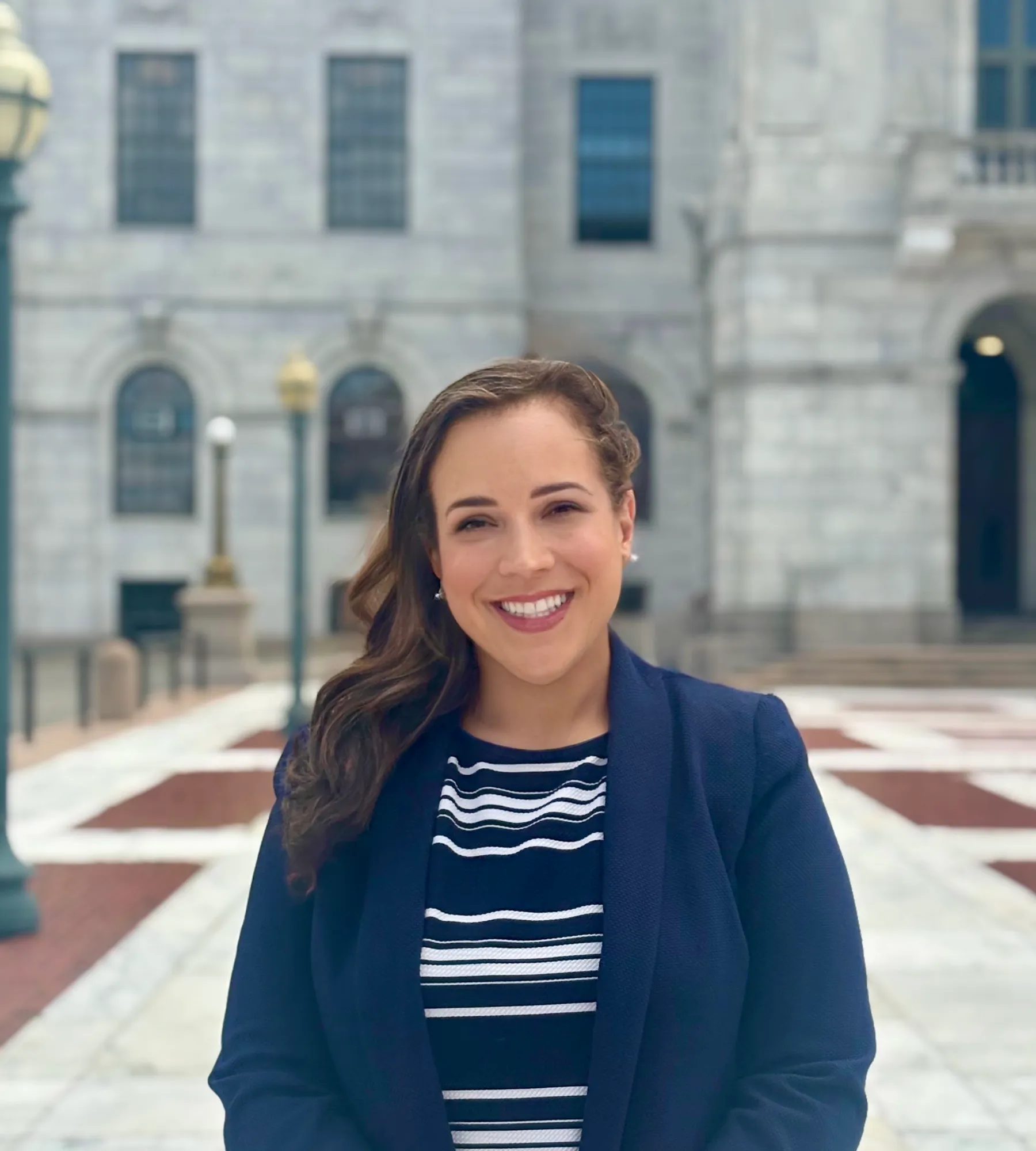 Suzy Alba standing in front of the State house